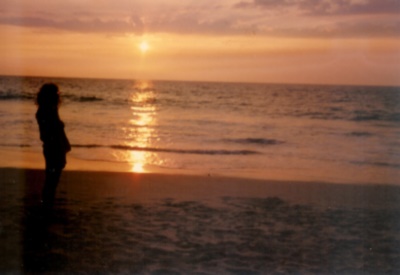 A figure gazes at a Hawaii sunset