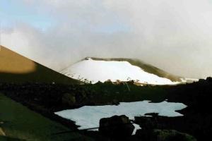 A snow covered crater at Mauna Kea's summit